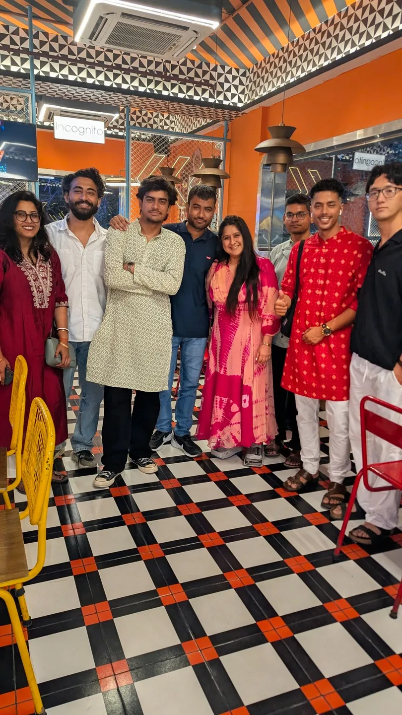 Friends standing together in a café before the Durga Puja outing