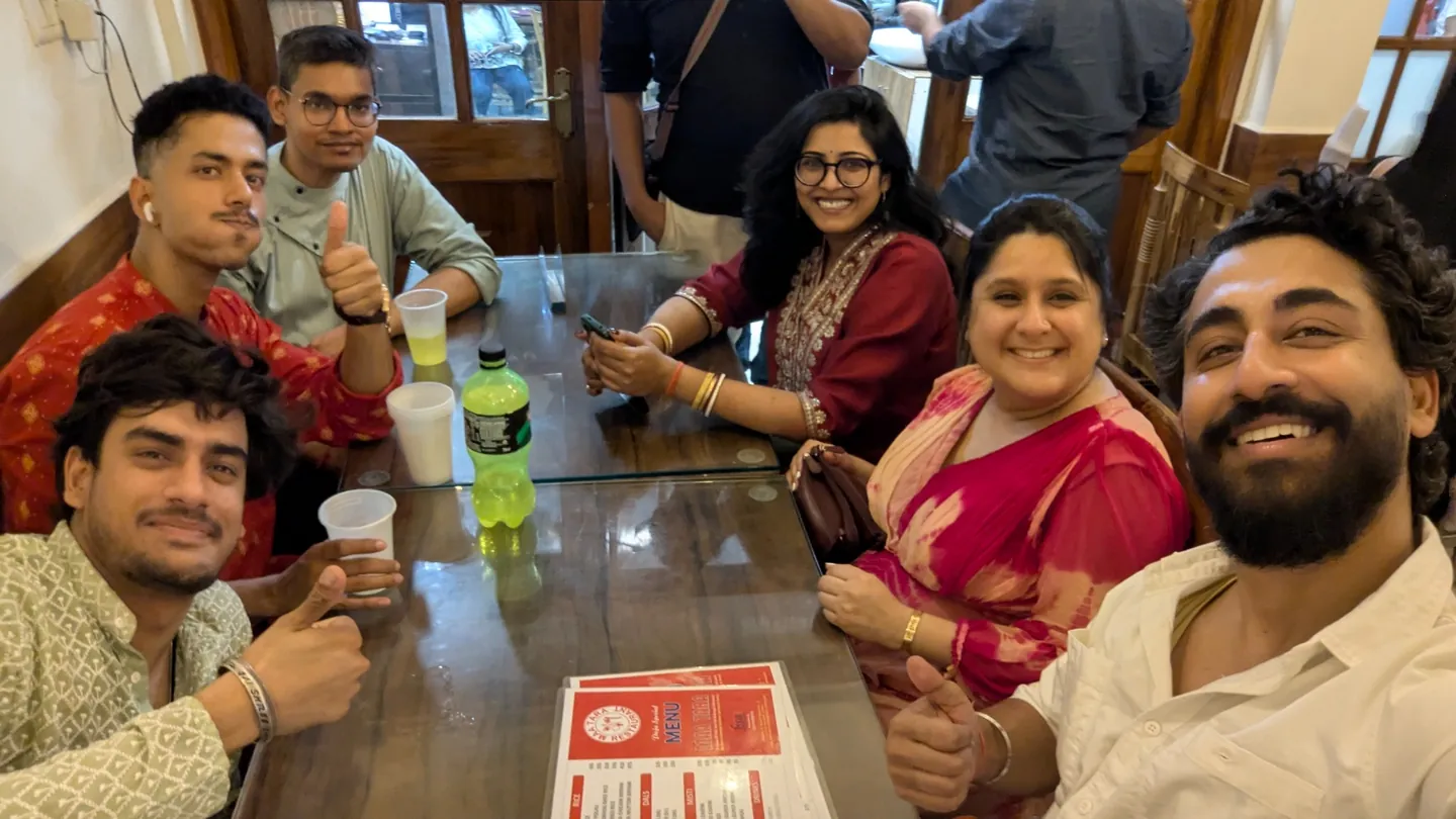 Friends smiling around a restaurant table after an evening out