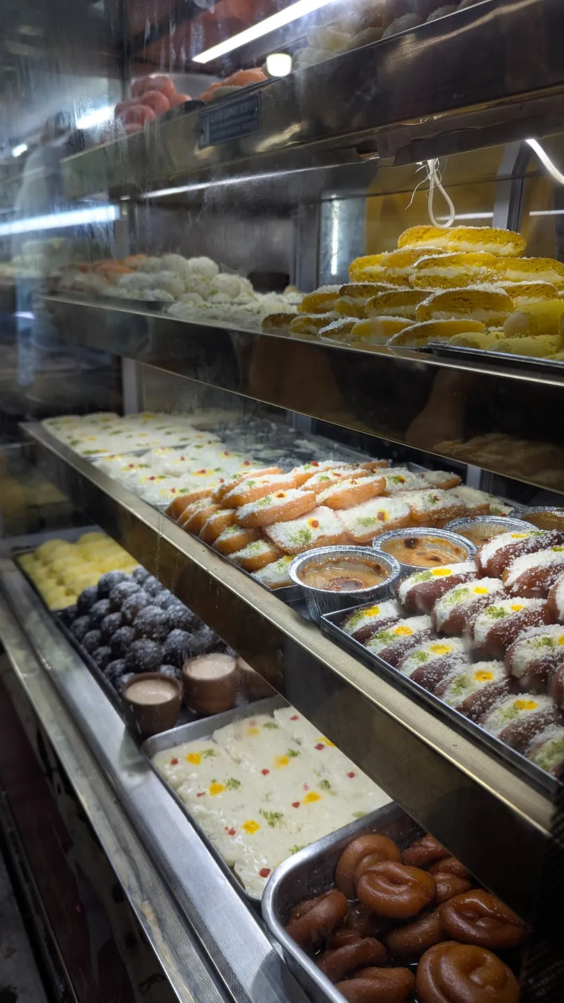 Trays of sweets arranged inside a glass-fronted sweet shop display